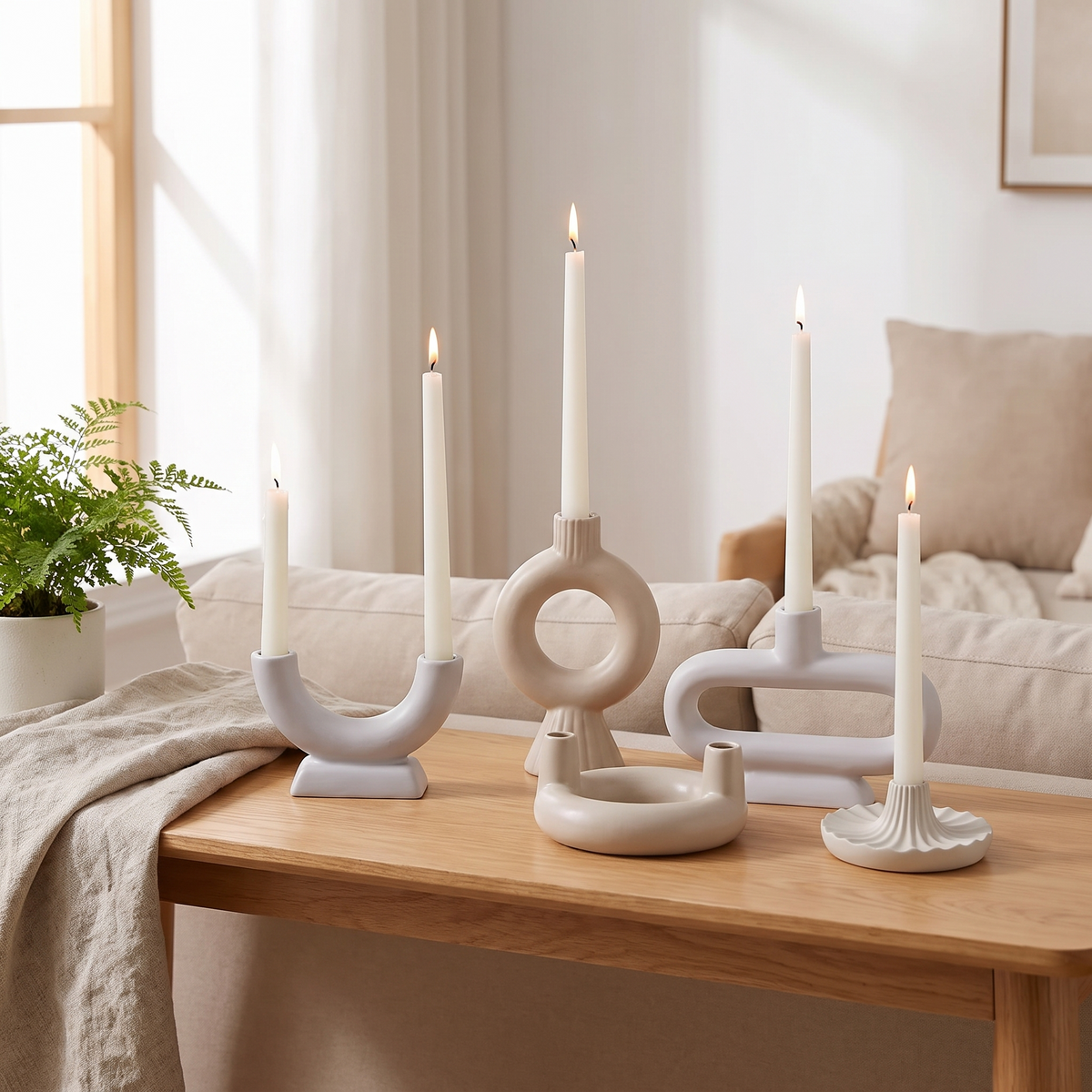 Nordic-style iron and glass candle holder styled on a warm wood console in a cozy Scandinavian living room